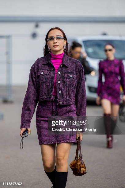 Guest is seen wearing purple denim jacket, skirt, knee high black socks outside Gestuz during Copenhagen Fashion Week Spring/Summer 2023 on August...