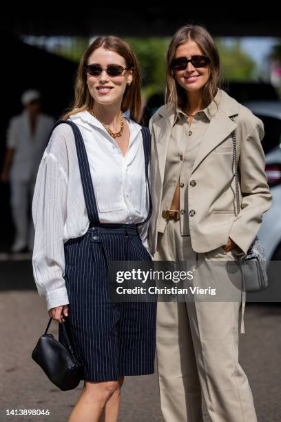 Annabel Rosendahl wearing white button shirt, black striped shorts & Darja Barannik wearing beige jacket, pants seen outside The Garment during...