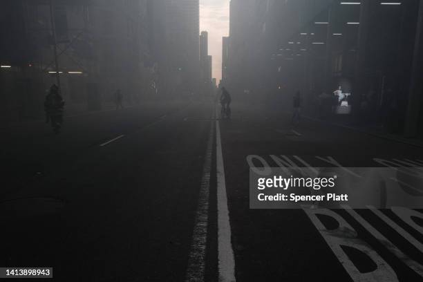 Smoke engulfs Fifth Avenue, blocks away from Trump Tower, as a fire breaks out in a building under construction on August 09, 2022 in New York City....