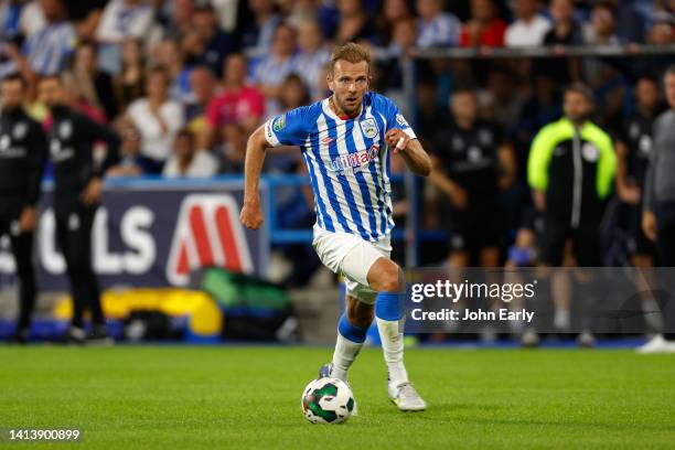 Jordan Rhodes of Huddersfield Town races through to score a consolation goal at The John Smith's Stadium on August 09, 2022 in Huddersfield, England.