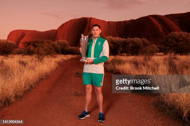 Scott Boland poses with the ICC Men's T20 World Cup Trophy Tour at Uluru on August 09, 2022 in Uluru, Australia. The T20 World Cup World Cup Trophy...