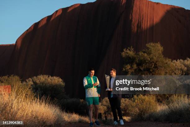 Scott Boland and Shane Watson pose with the ICC Men's T20 World Cup Trophy Tour at Uluru on August 09, 2022 in Uluru, Australia. The T20 World Cup...