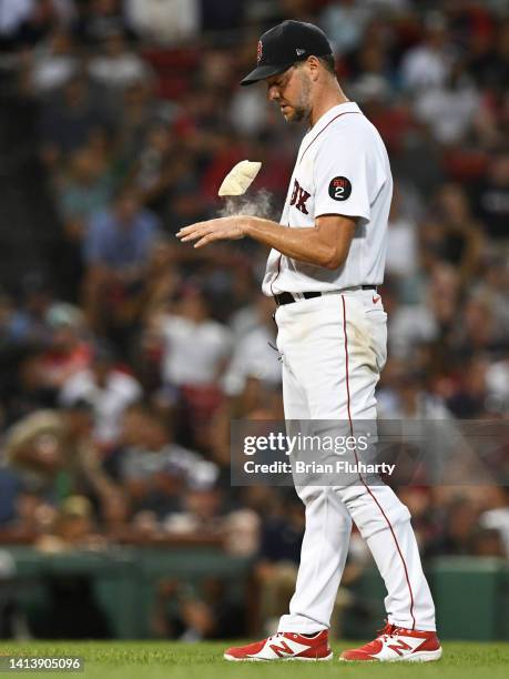 Rich Hill of the Boston Red Sox tosses the rosin bag after giving up a two-run home run against Austin Riley of the Atlanta Braves in the third...