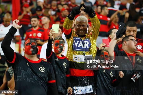 Fan of Flamengo dressed as VAR gestures for the camera prior a Copa CONMEBOL Libertadores quarter final second leg match between Flamengo and...