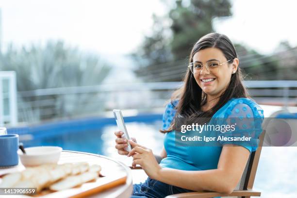 woman using smartphone at leisure area - financial freedom stock pictures, royalty-free photos & images