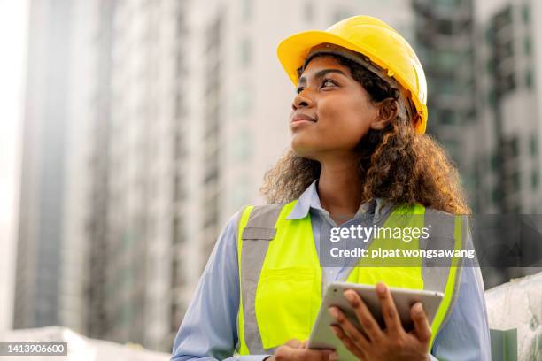 african female engineer american is looking forward with determination, leadership concept, progress - architekt helm plan stock-fotos und bilder