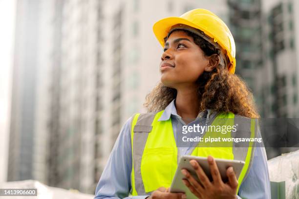 african female engineer american is looking forward with determination, leadership concept, progress - ouvrier du bâtiment photos et images de collection