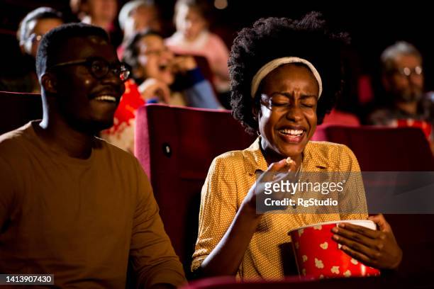 african-american couple having fun on a comedy movie premiere - 50 watching video stock pictures, royalty-free photos & images