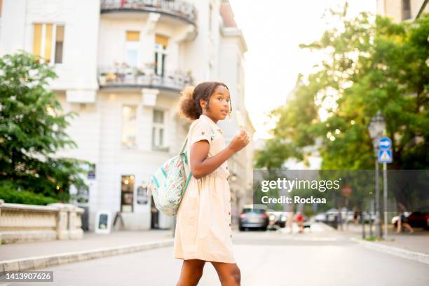 portrait of a cute girl with a backpack going to school - cross road children stock pictures, royalty-free photos & images