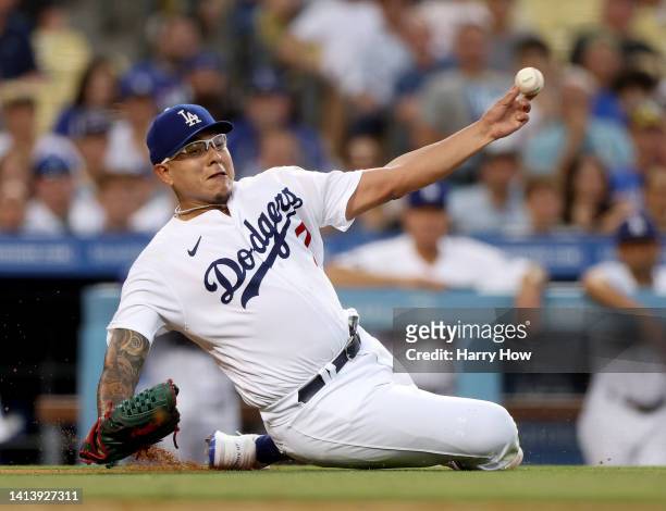 Julio Urias of the Los Angeles Dodgers makes a throw to first base on an infield RBI single from Gilberto Celestino of the Minnesota Twins, for a 1-1...