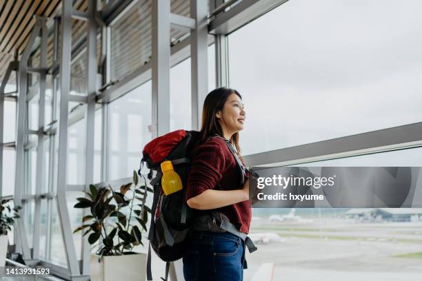asian woman backpacker waiting for flight in airport - water bottle stock pictures, royalty-free photos & images