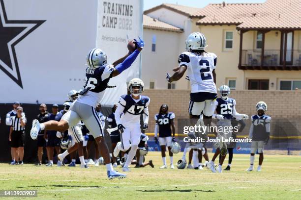 Cornerback Kyron Brown intercepts the ball intended for wide receiver KaVontae Turpin during the Dallas Cowboys training camp at River Ridge Fields...