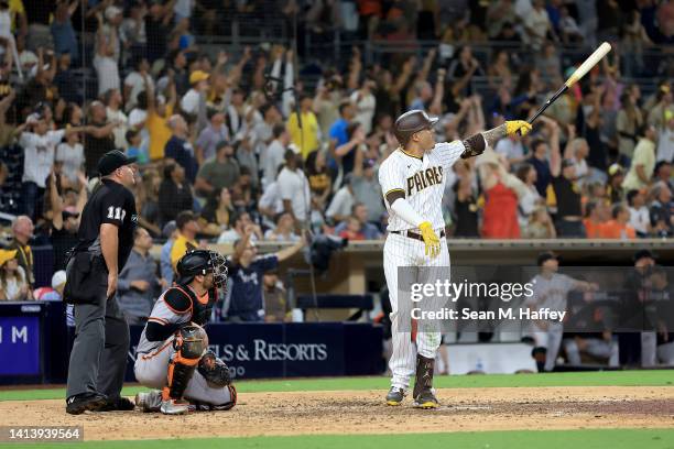 Manny Machado of the San Diego Padres reacts after hitting a three-run homerun as Austin Wynns of the San Francisco Giants looks on during the ninth...