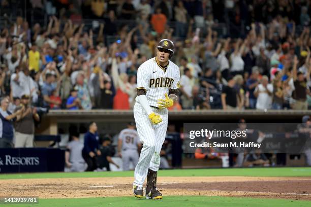 Manny Machado of the San Diego Padres reacts after hitting a three-run homerun during the ninth inning of a game against the San Francisco Giants at...