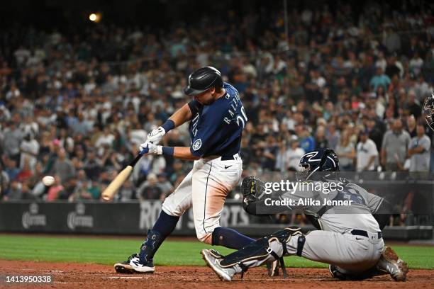 Cal Raleigh of the Seattle Mariners hits a single during the thirteenth inning against the New York Yankees at T-Mobile Park on August 09, 2022 in...