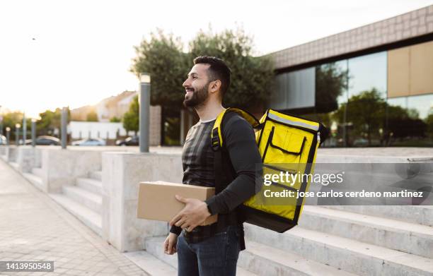 delivery man on foot city - shopping with bike stock-fotos und bilder