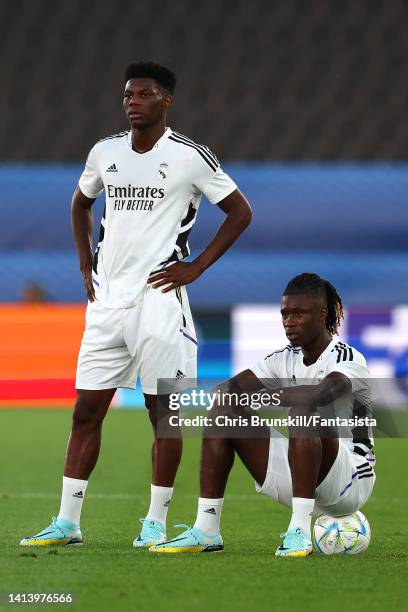 Aurelien Tchouameni of Real Madrid looks on next to team-mate Eduardo Camavinga during the Real Madrid CF training session ahead of the UEFA Super...