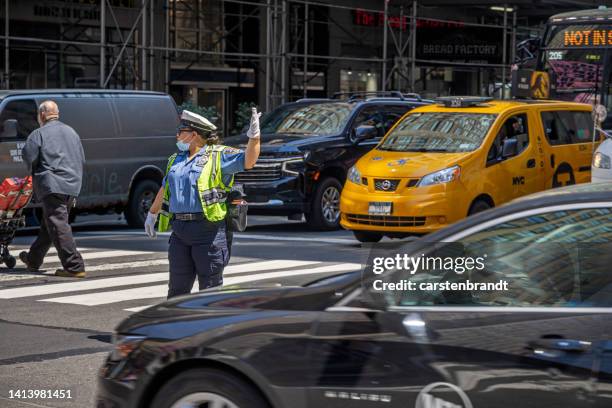 female police officer regulating the traffic - verkeerspolitie stockfoto's en -beelden