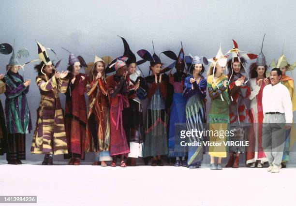 Fashion designer Issey Miyake and models walk the runway during the Issey Miyake Ready to Wear Fall/Winter 1997-1998 fashion show as part of Paris...