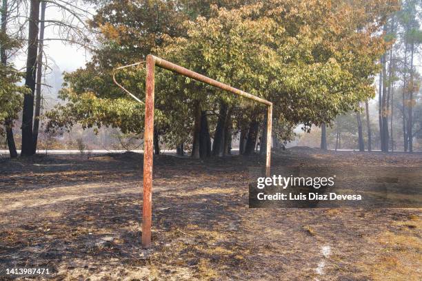 soccer field burned in forest fire. - südeuropa stock-fotos und bilder