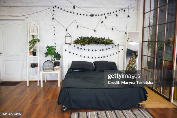 new year's decor in a modern bedroom. christmas. festive home decor. - headboard stock pictures, royalty-free photos & images