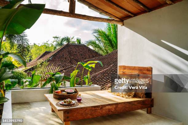 healthy breakfast in bed at tropical resort with avocado and fruit - balcony decoration stock pictures, royalty-free photos & images
