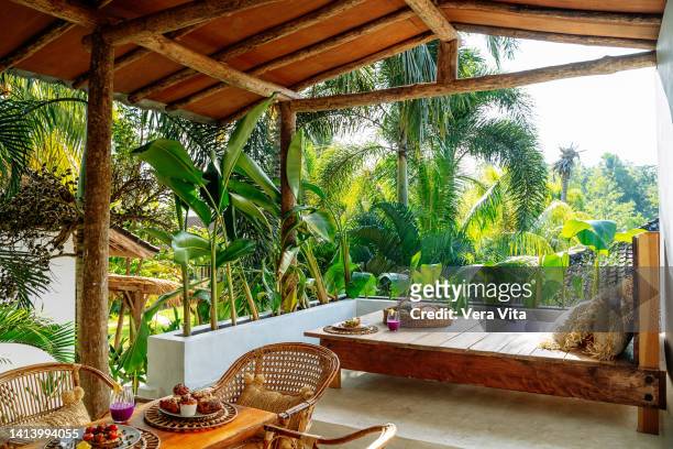 healthy breakfast in bed at tropical resort with palm trees on background - bali stockfoto's en -beelden