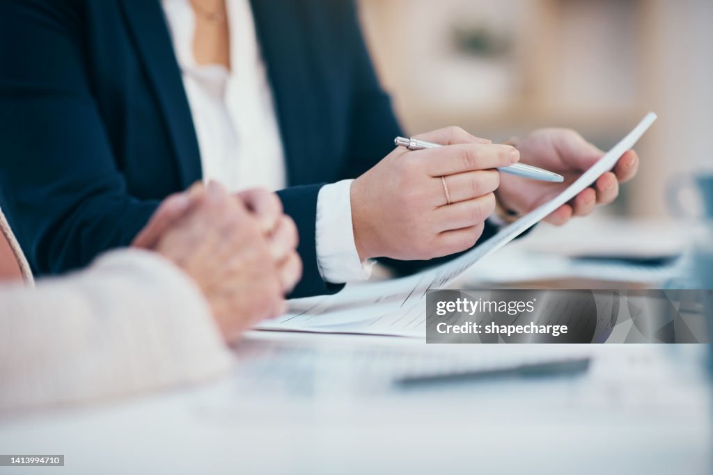Hands closeup on contact, legal settlement or financial report while reading and making notes. Lawyer team doing work and analyzing documents. Lawyers looking through client finance data together