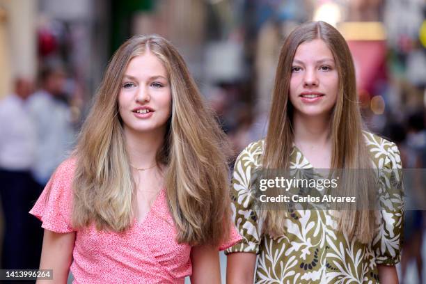 Crown Princess Leonor of Spain and Princess Sofia of Spain are seen walking through the city center during their vacations on August 10, 2022 in...