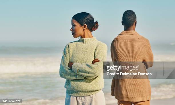 couple, relationship and marriage problems while traveling together and spending time at the beach. upset, unhappy and angry man and woman ignoring each other after a fight,  arguing or quarrel - couple counselling stock pictures, royalty-free photos & images