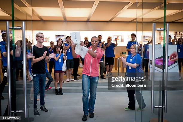 Jonathan Hakim holds the new Apple Inc. IPad as he exits the company's George Street store after the launch of the device in Sydney, Australia, on...