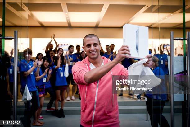 Jonathan Hakim holds the new Apple Inc. IPad as he exits the company's George Street store after the launch of the device in Sydney, Australia, on...