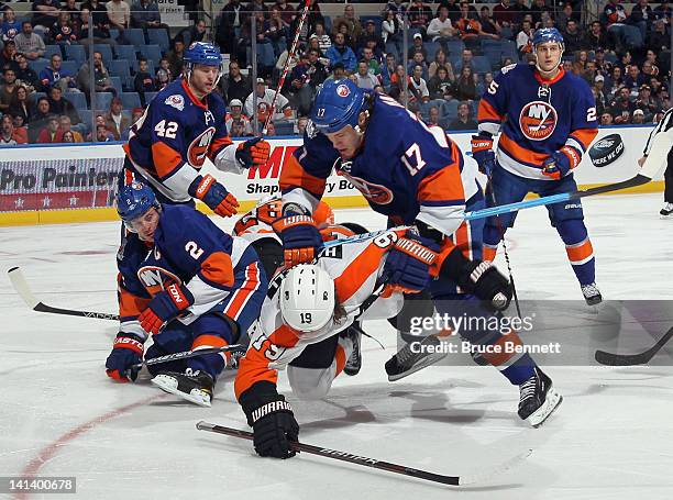 Matt Martin of the New York Islanders knocks down Scott Hartnell of the Philadelphia Flyers at the Nassau Veterans Memorial Coliseum on March 15,...