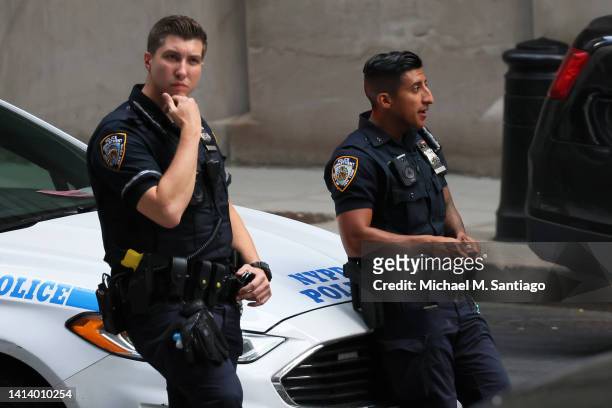 Officers stand watch as they await the arrival of former President Donald Trump at the office of the NYS Attorney General on August 10, 2022 in New...
