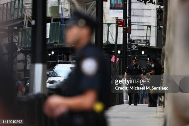 Officers stand watch as they await the arrival of former President Donald Trump at the office of the NYS Attorney General on August 10, 2022 in New...
