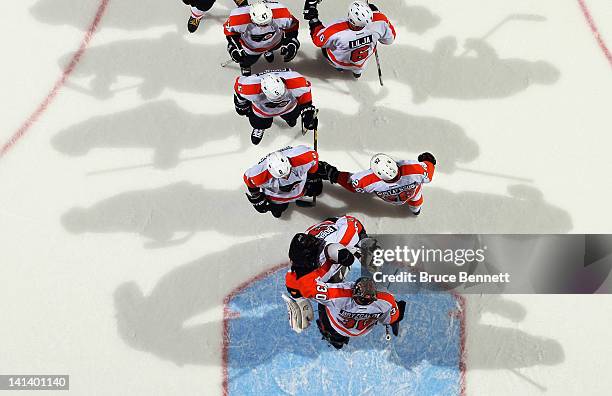 The Philadelphia Flyers line up to congratulate Ilya Bryzgalov on a 3-2 victory over the New York Islanders at the Nassau Veterans Memorial Coliseum...