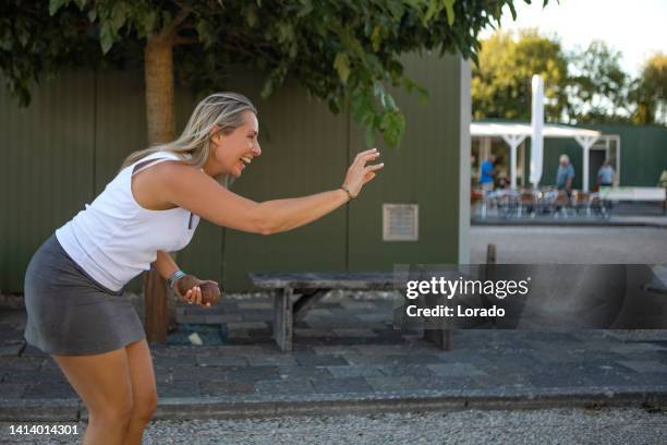 beautiful active middle aged female playing boules in the summer - petanque stock pictures, royalty-free photos & images