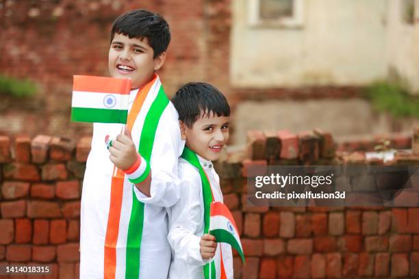 two siblings of elementary age holding national indian flag in hands - happy independence day stock pictures, royalty-free photos & images