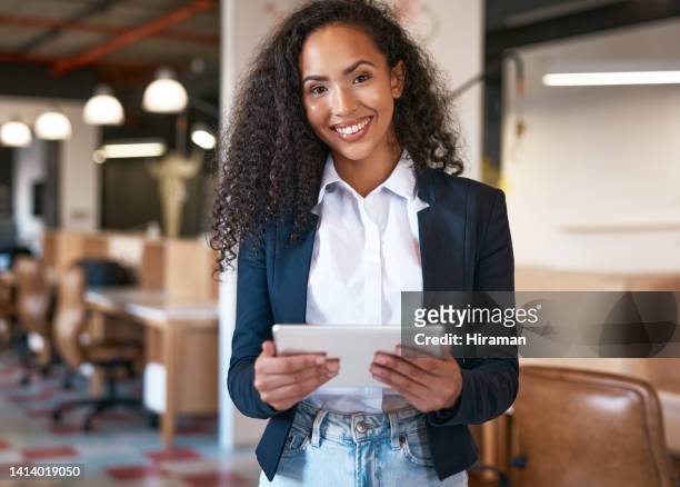 confident, smiling and stylish business owner standing inside a retro office room and holding tablet. portrait of happy, cheerful and friendly african female entrepreneur, manager or boss - happy ipad beautiful stockfoto's en -beelden