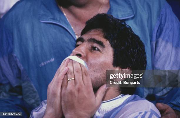 Argentine professional football player Diego Armando Maradona kisses his Argentina national football team shirt celebrating victory after the...