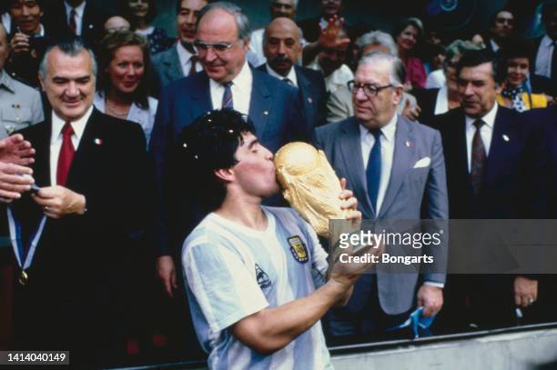 Argentine professional football player Diego Armando Maradona kisses the World Cup trophy after Argentina defeated West Germany 3-2 during the 1986...