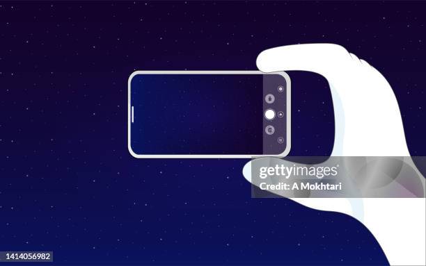 astronaut taking a photo with a smartphone. - astronaut hand stock illustrations