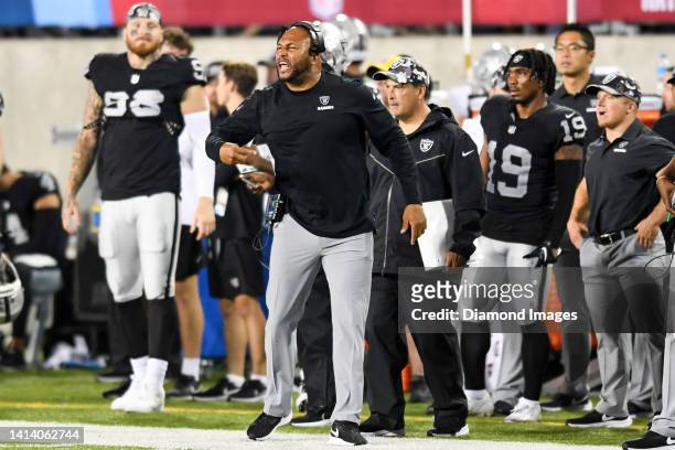 Linebackers coach Antonio Pierce of the Las Vegas Raiders yells to players during the second half of the 2022 Pro Football Hall of Fame Game against...