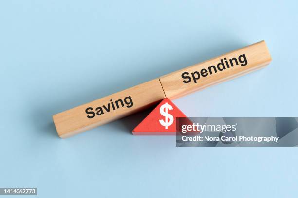 financial imbalance saving and spending - geld verheizen stock-fotos und bilder