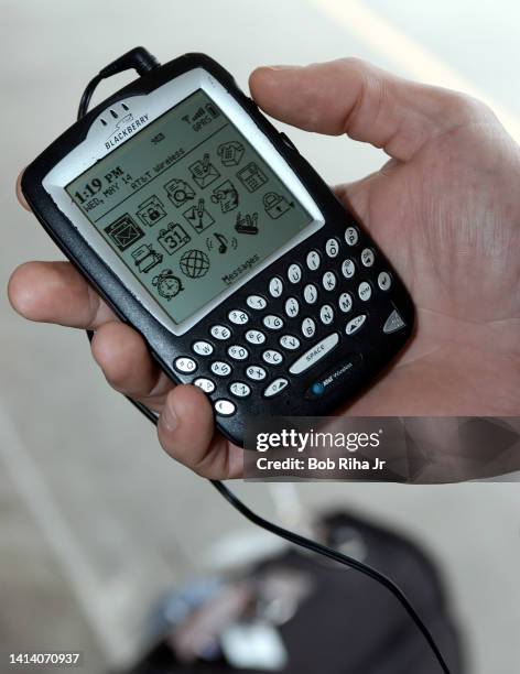 Business traveler Paul Belliveau uses his BlackBerry device for email and as a cell phone for business trips, May 14, 2003 in Los Angeles, California.