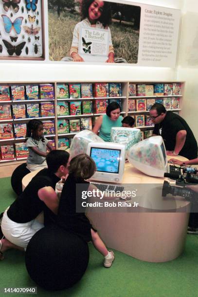 Children and their parents try-out a new iMac computers during the grand opening of The Apple Store, May 19, 2001 in Glendale, California. Apple...