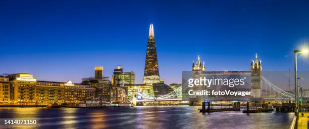 london the shard overlooking tower bridge thames illuminated sunset panorama - london bridge stock pictures, royalty-free photos & images