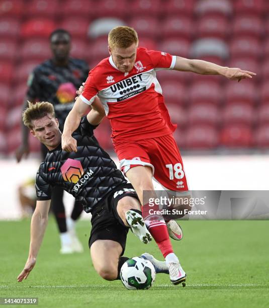 Barnsley player Luca Connell challenges Middlesbrough striker Duncan Watmore during the Carabao Cup First Round match between Middlesbrough and...