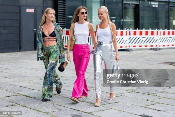 Jeanette Friis Madsen & Thora Valdimars wearing silver pants seen outside Remain during Copenhagen Fashion Week Spring/Summer 2023 on August 09, 2022...