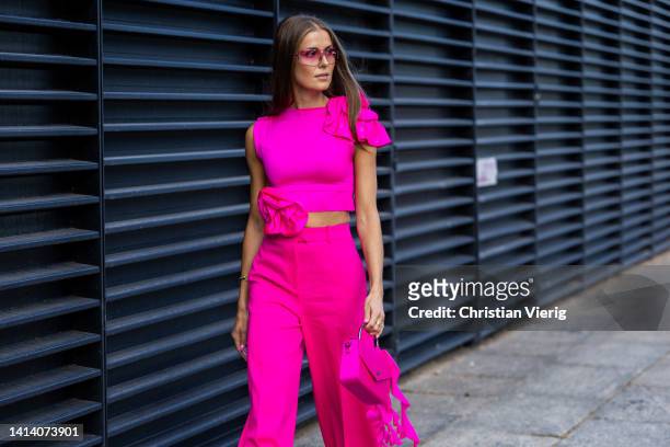 Nina Sandbech seen wearing pink cropped top, pants, bag outside Remain during Copenhagen Fashion Week Spring/Summer 2023 on August 09, 2022 in...